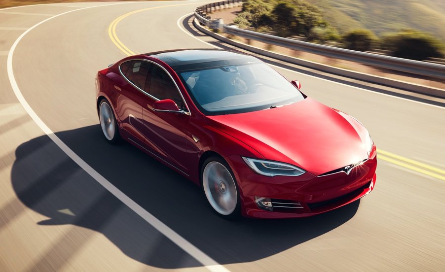 A red Tesla Model S on the open road