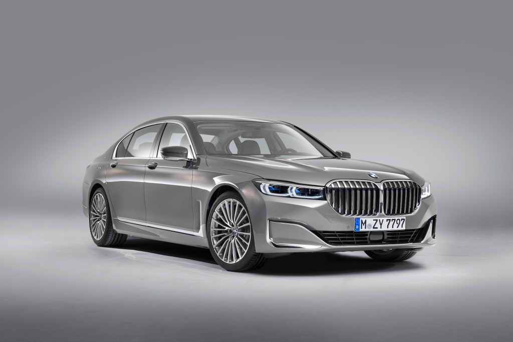 A silver 2020 BMW 7 Series parked in a photo studio