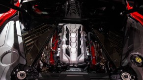 The engine of a red 2020 Chevy Corvette C8 Stingray sports car on display during an unveiling event in Tustin, California, in July 2019