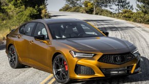 A gold 2021 Acura TLX Type S on a twisting mountain road