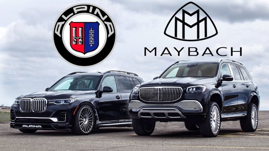 A black 2021 BMW Alpina XB7 at its lowest height next to a black 2021 Mercedes-Maybach GLS 600 at its highest height