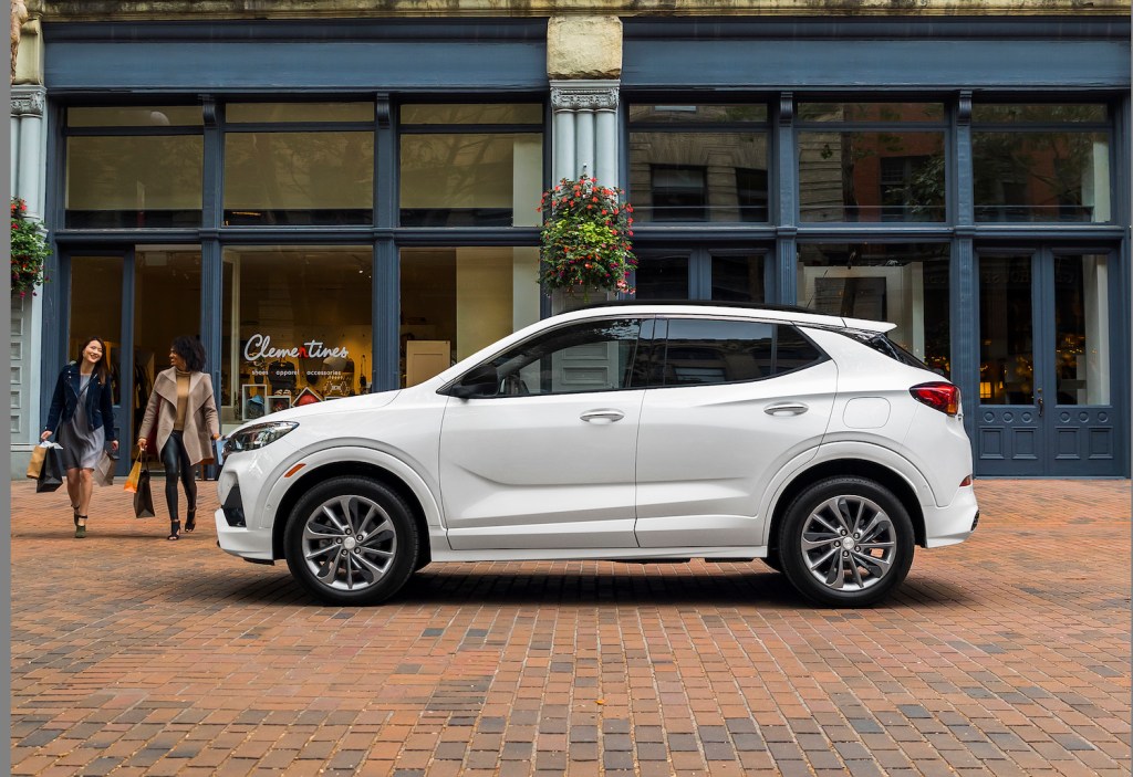 A white 2021 Buick Encore GX in front of a store, the Encore GX is one of the best affordable luxury cars under $35,000