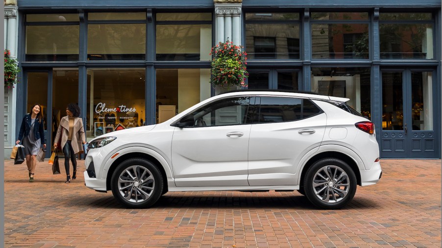A white 2021 Buick Encore GX in front of a store, the Encore GX is one of the best affordable luxury cars under $35,000