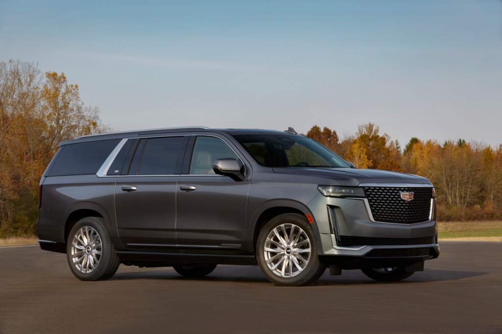 A dark 2021 Cadillac Escalade parked in front of trees 