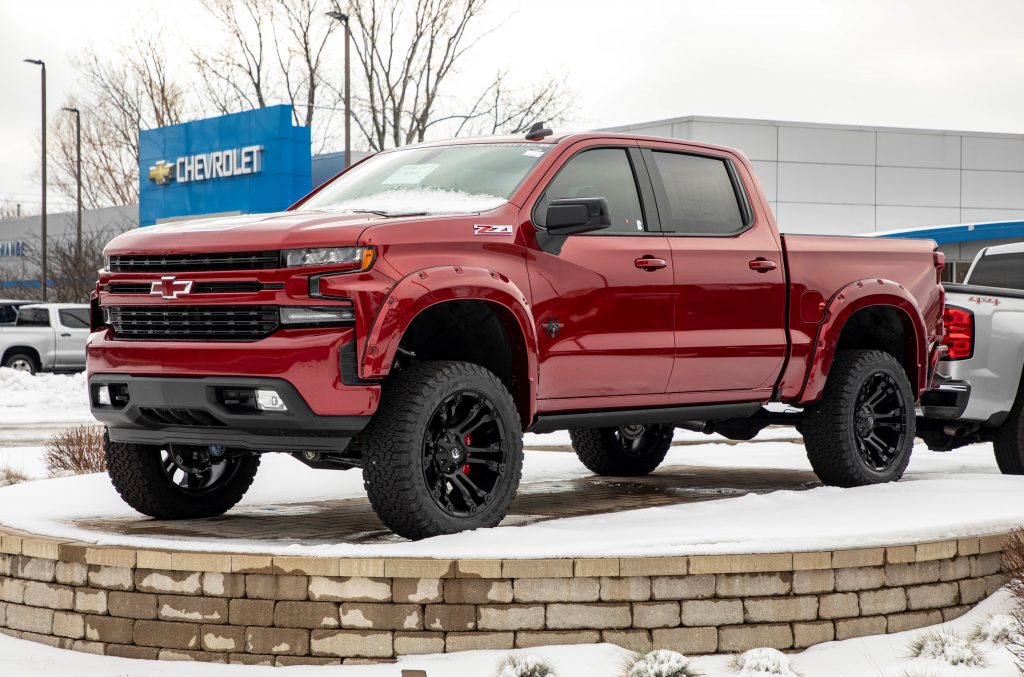 A slick red 2021 Chevy Silverado Z71 is on display outdoors at the Exchange Chevrolet, topping off Consumer Reports least reliable vehicles of 2021. 