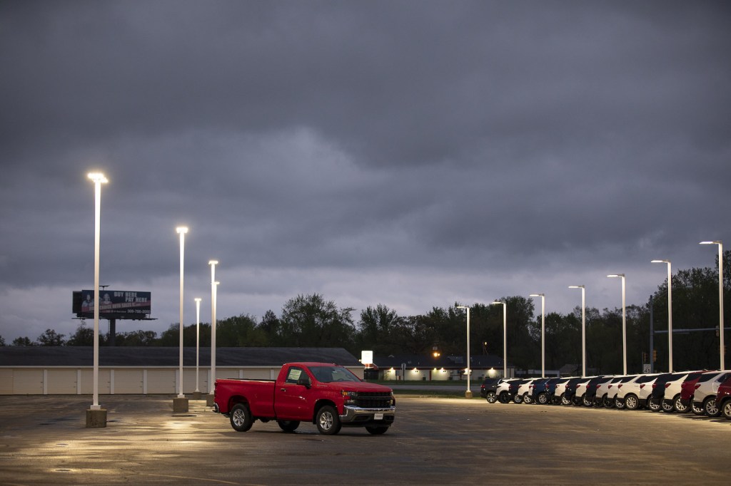 A red 2021 Chevy Silverado in an empty parking lot