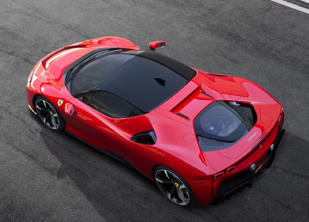 An overhead rear 3/4 view of a red 2021 Ferrari SF90 Stradale on a racetrack