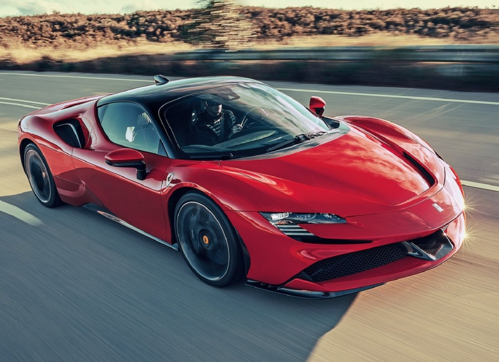 A red 2021 Ferrari SF90 Stradale driving down the highway