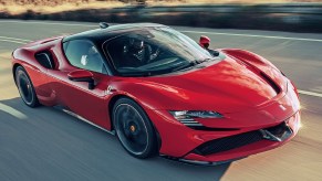 A red 2021 Ferrari SF90 Stradale driving down the highway