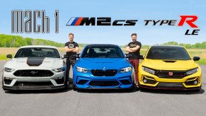 A gray-black-and-orange 2021 Ford Mustang Mach 1 next to a blue 2021 BMW M2 CS next to a yellow 2021 Honda Civic Type R Limited Edition on the Throttle House track