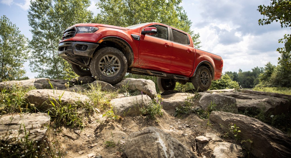 a red 2021 Ford Ranger pickup truck crawling up rocks