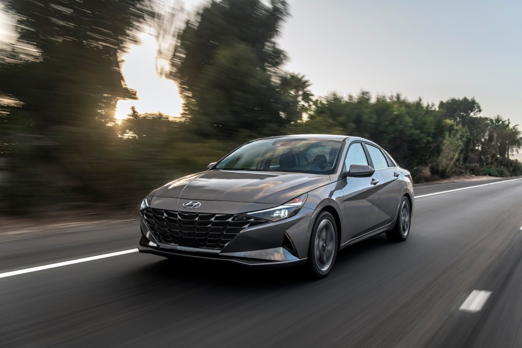 A dark grey 2021 Hyundai Elantra Hybrid driving