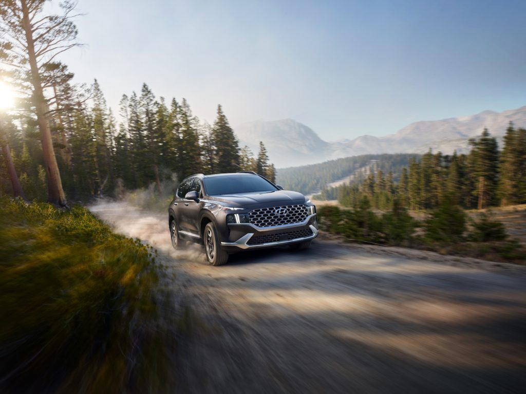 A 2021 Hyundai Santa Fe Hybrid driving on a sunny day