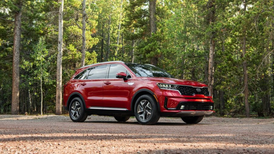 The red 2021 Kia Sorento HEV Hybrid parked in the middle of a forest