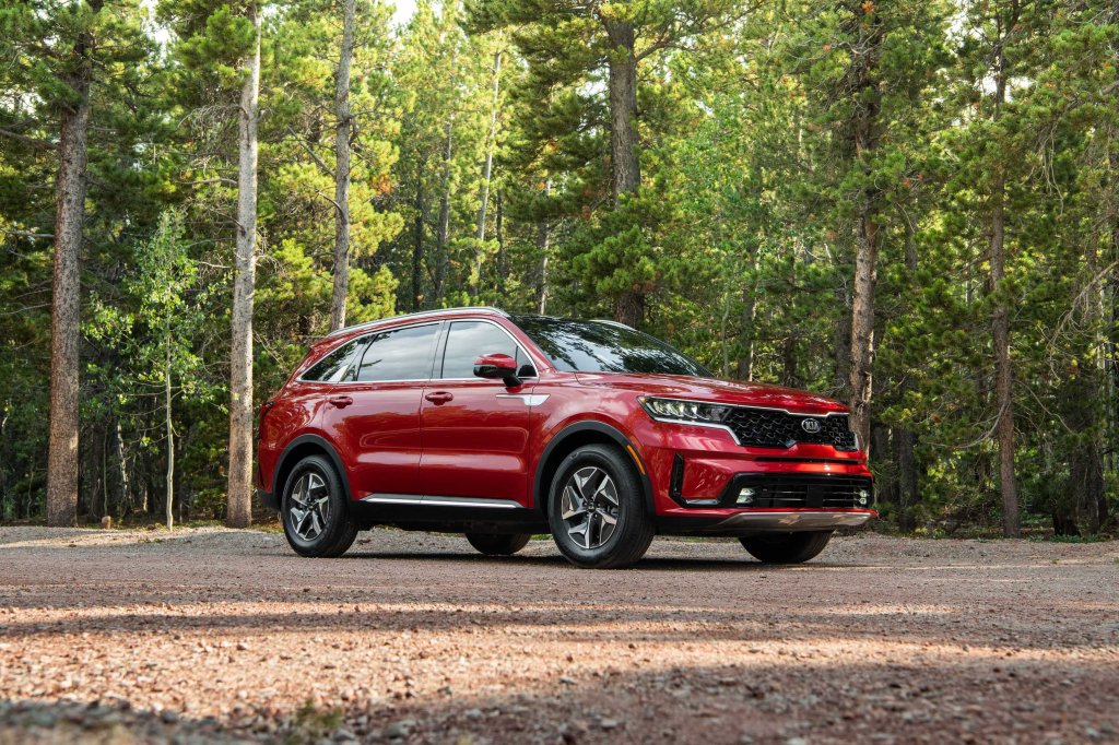 The red 2021 Kia Sorento HEV Hybrid parked in the middle of a forest