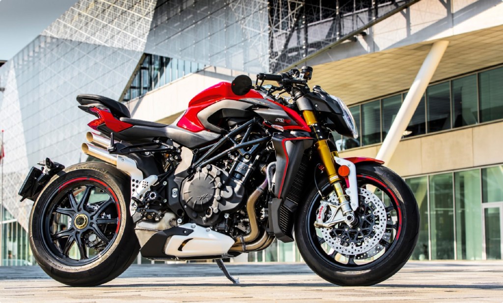 The side view of a red-and-black 2021 MV Agusta Brutale 1000 RR in front of a modern building