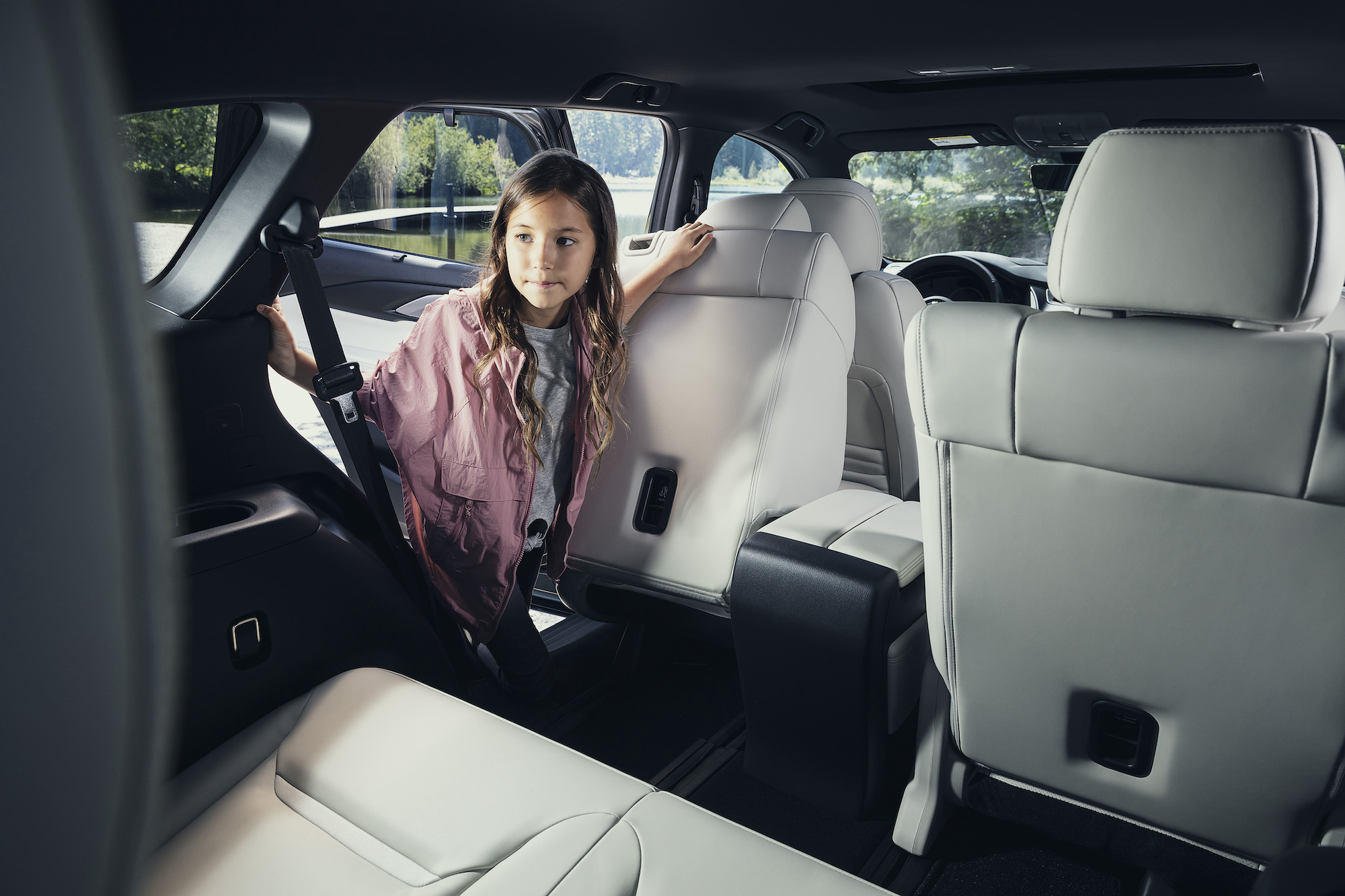 A girl looks inside a 2021 Mazda CX-9 SUV