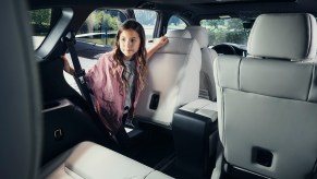 A girl looks inside a 2021 Mazda CX-9 SUV