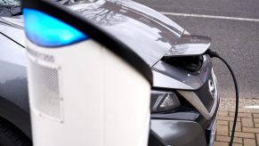 A gray 2021 Nissan Leaf EV sedan at a sharging station