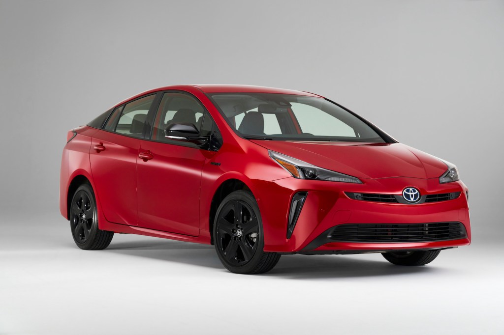 A red 2021 Toyota Prius with nothing behind it