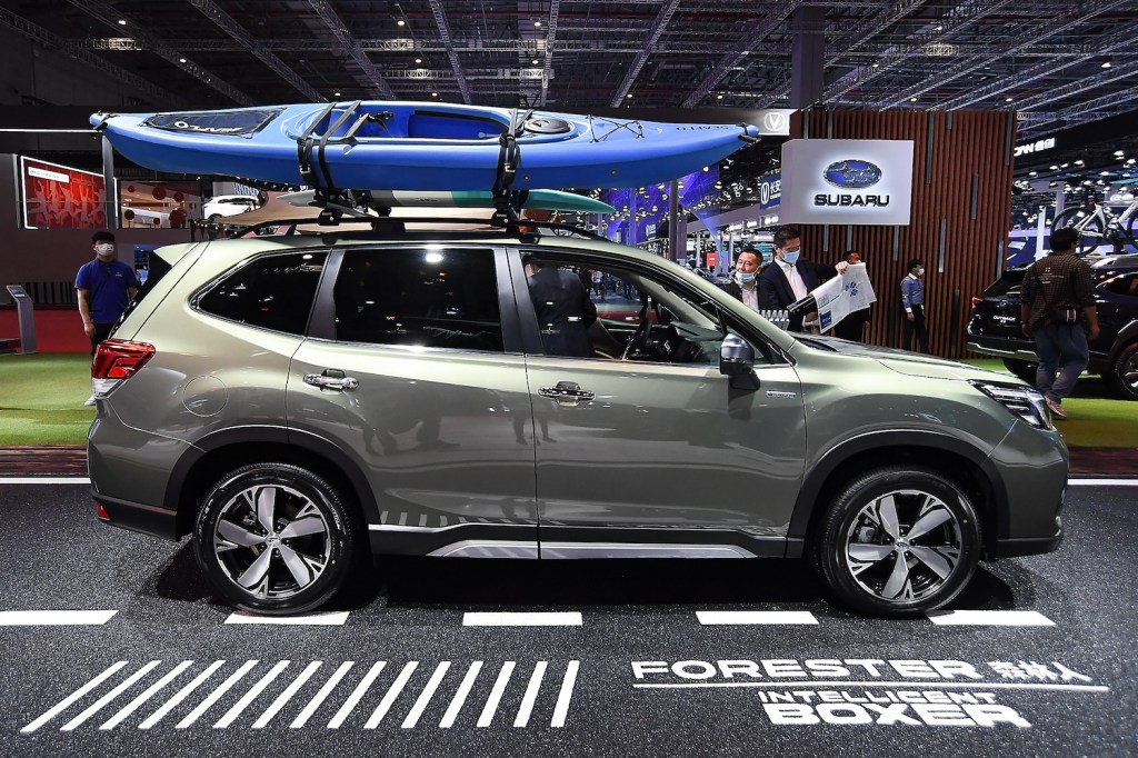 A green 2021 Subaru Forester with a kayak on top of it, the Subaru Forester is among the best new cars under $30,000