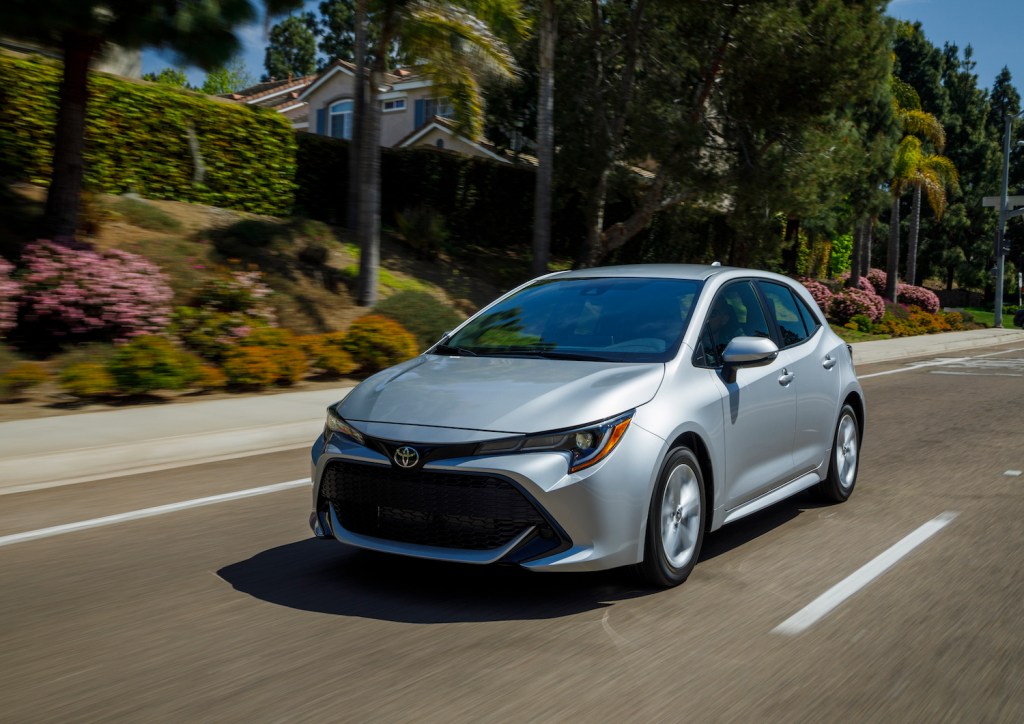A silver 2021 Toyota Corolla Hatchback driving