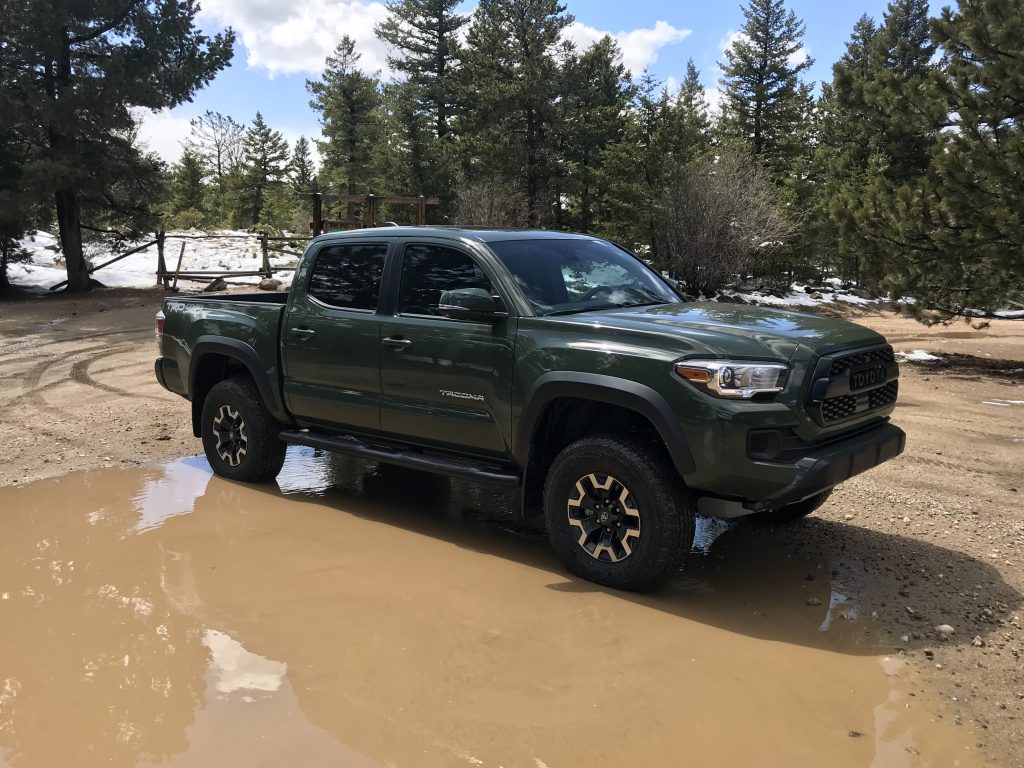 The lifted 2021 Toyota Tacoma TRD Off Road in a puddle