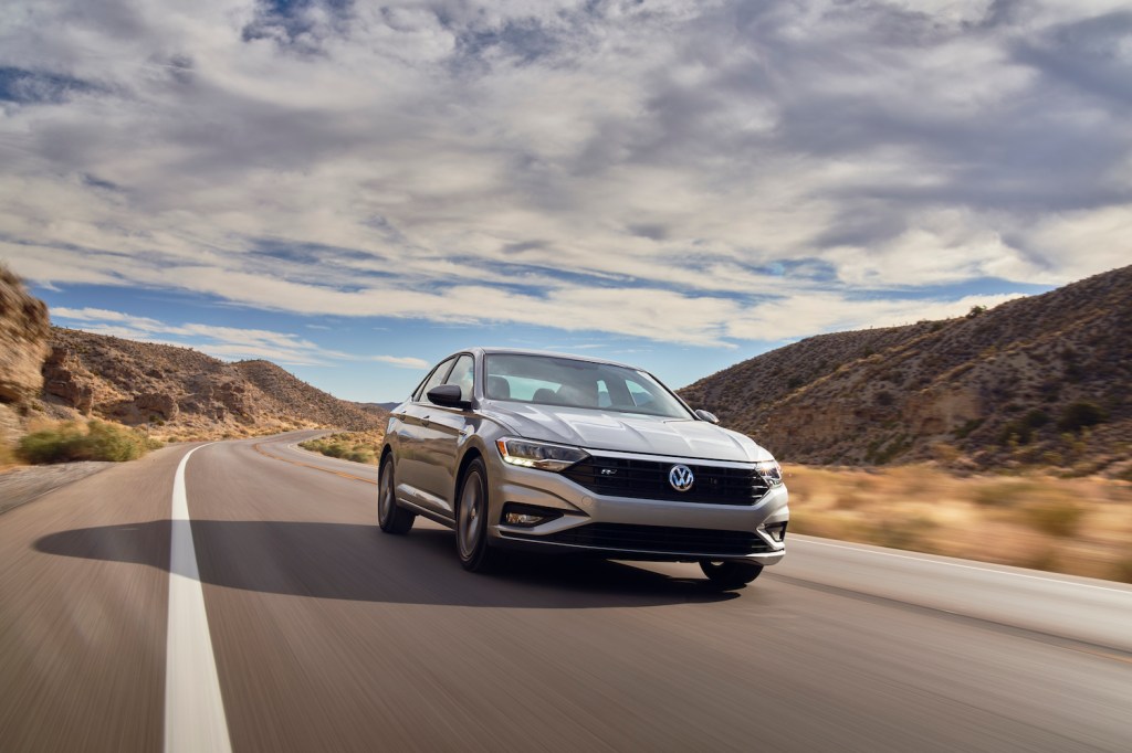A silver 2021 Volkswagen Jetta driving