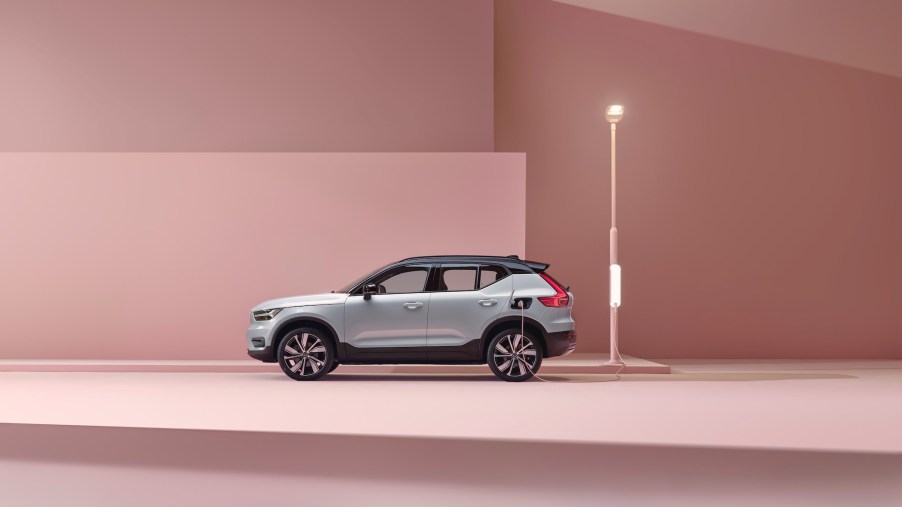 A 2021 Volvo XC40 Recharge P8 all-wheel-drive SUV in Glacier Silver sitting in a pink studio