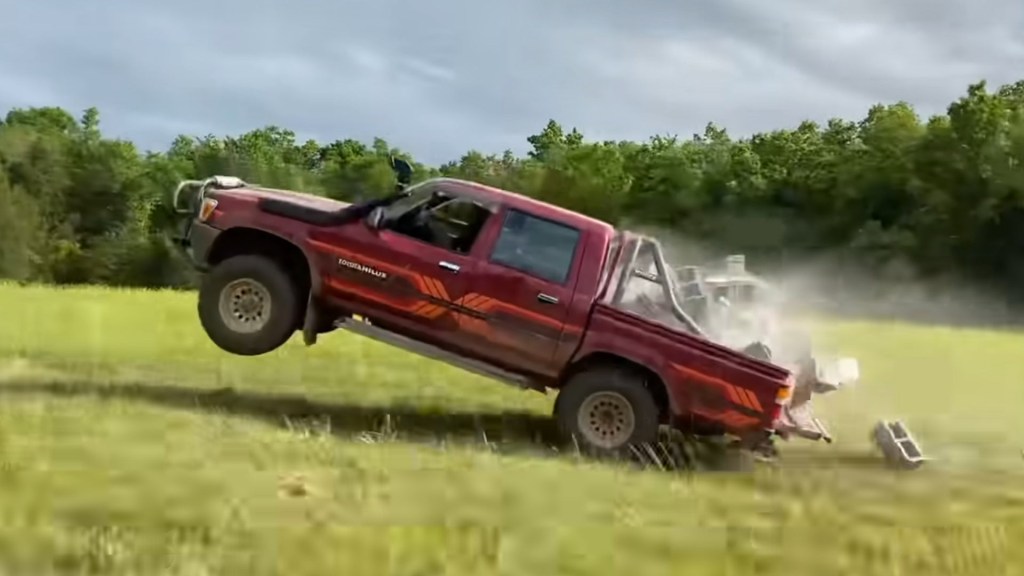 Toyota Hilux popping a wheelie becuase its full of bricks