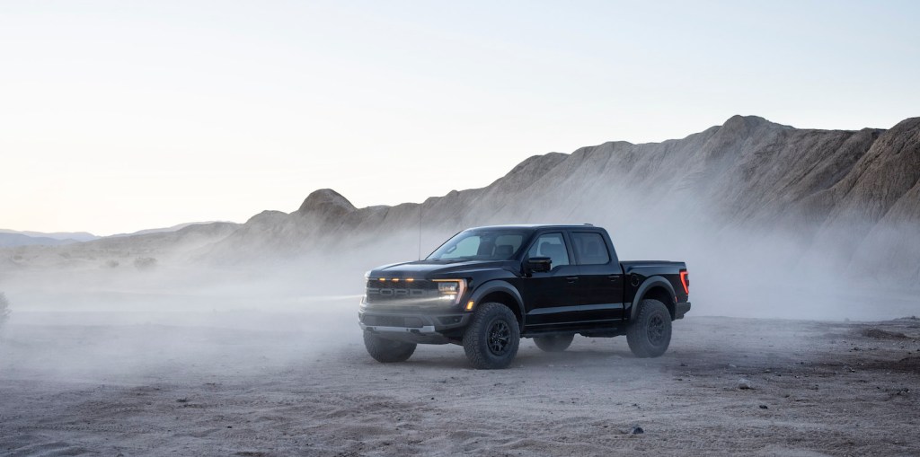 A Black 2021 Ford Raptor parked in the dust