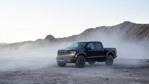 A Black 2021 Ford Raptor parked in the dust