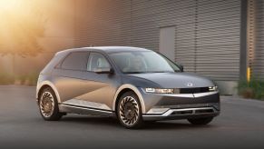 A gray-silver 2022 Hyundai Ioniq 5 in the parking lot of a gray building