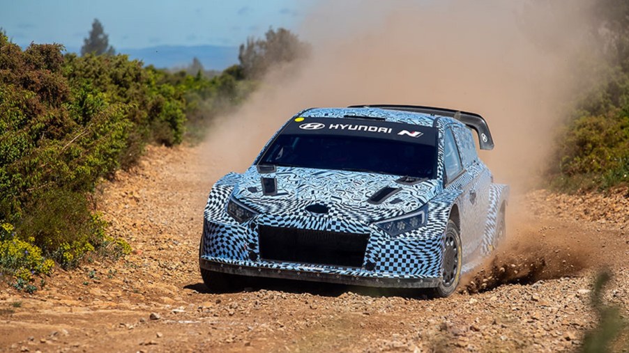 The blue-and-white-camouflaged 2022 Hyundai i20 N Rally1 prototype testing on a gravel rally stage