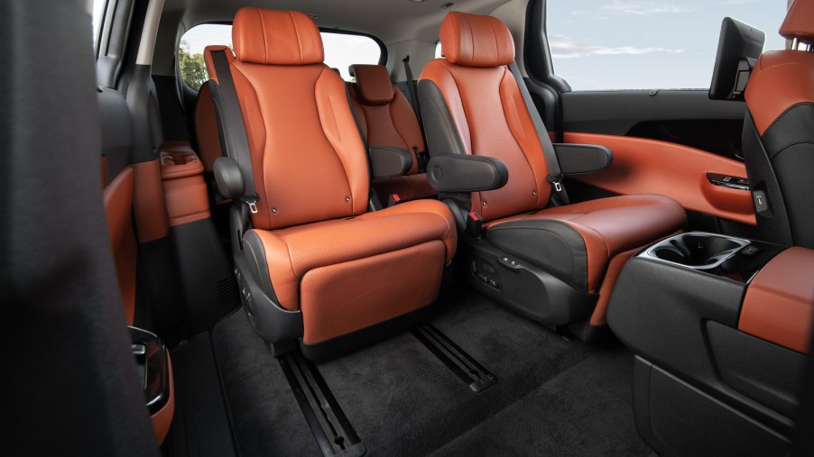 A 2022 Kia Carnival MPV's dark-gray and burnt-orange leather seating