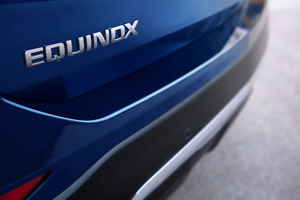 An Equinox badge on a blue SUV