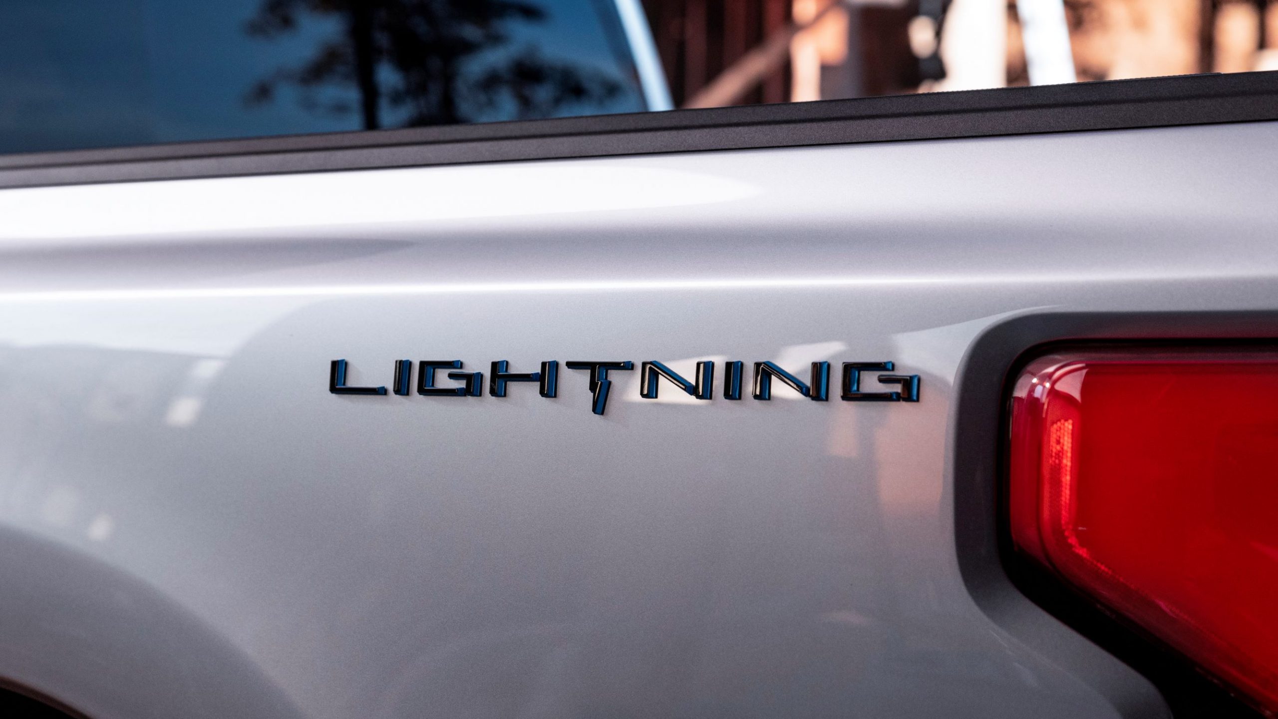 A close-up view of the badge on the side of Ford F-150 Lightning's bed