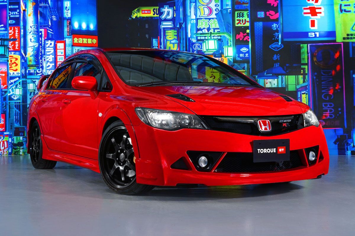 An image of a red Honda Civic Mugen RR in a dealership.