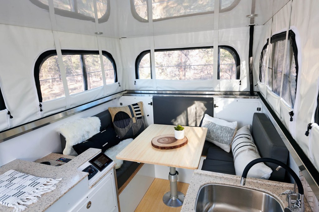go between a dining are/workspace/bedroom in the efficient design of this all-new overland camper