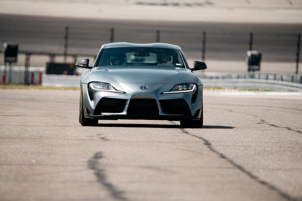 The matte gray 2021 Toyota GR Supra on the track at Texas Motor Speedway for the Texas Auto Roundup 