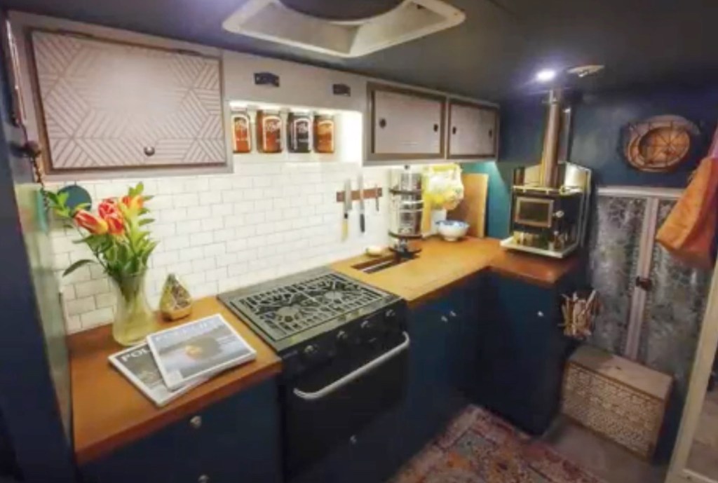 the interior of the camper van with a view of the functional full kitchen 