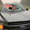 A Ford F-150 with a broken windshield by the side of the highway in Florida