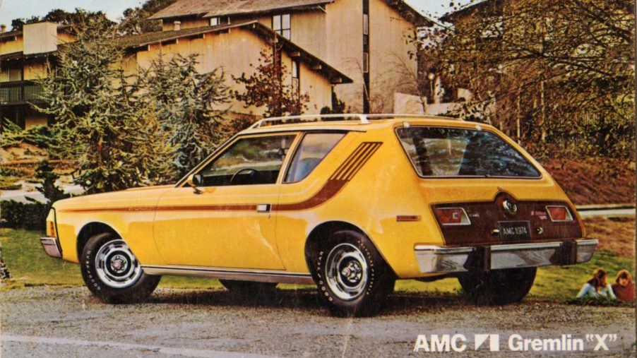 A yellow AMC Gremlin is parked in a 70s suburban neighborhood and ranks in many most hated cars lists