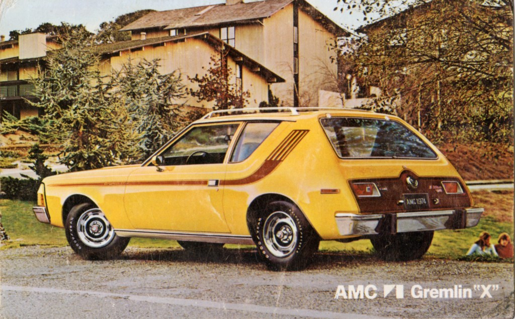 A yellow AMC Gremlin is parked in a 70s suburban neighborhood and ranks in many most hated cars lists.