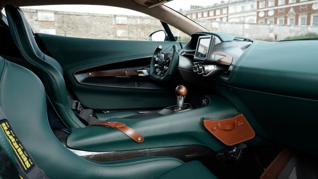 The green and carbon fiber interior of the Victor, with a stick shift gear knob rising out of the center console