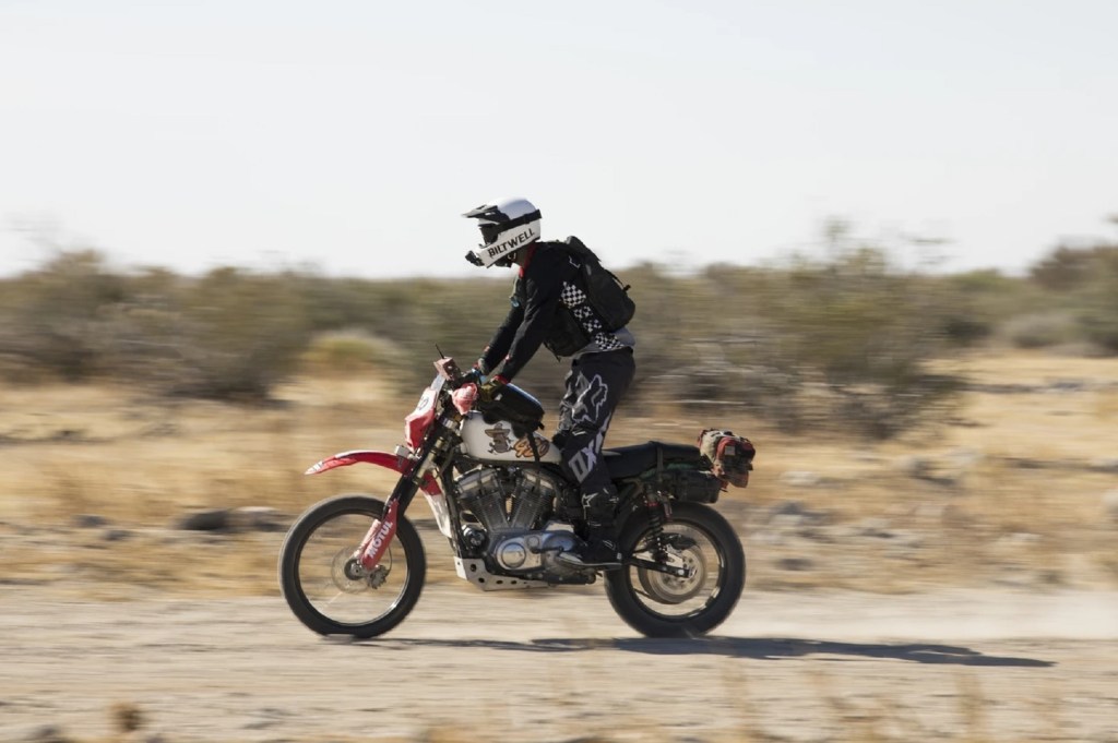 The red-and-white Biltwell Harley-Davidson Iron 883 Sportster scrambler 'Frijole 883' racing in the NORRA Mexican 1000