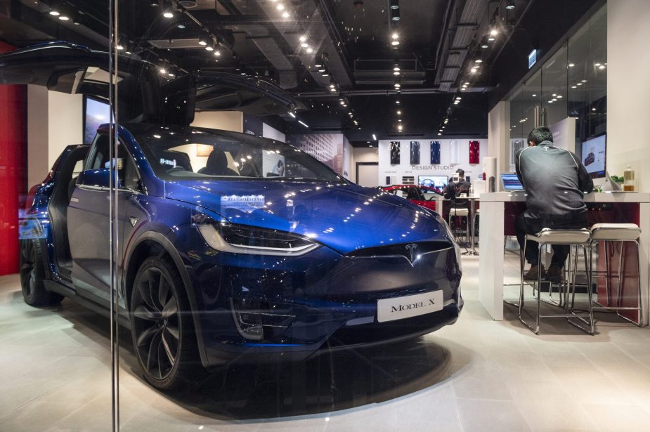 American electric company car Tesla Motors official authorized car dealer store as it displays the blue Model X
