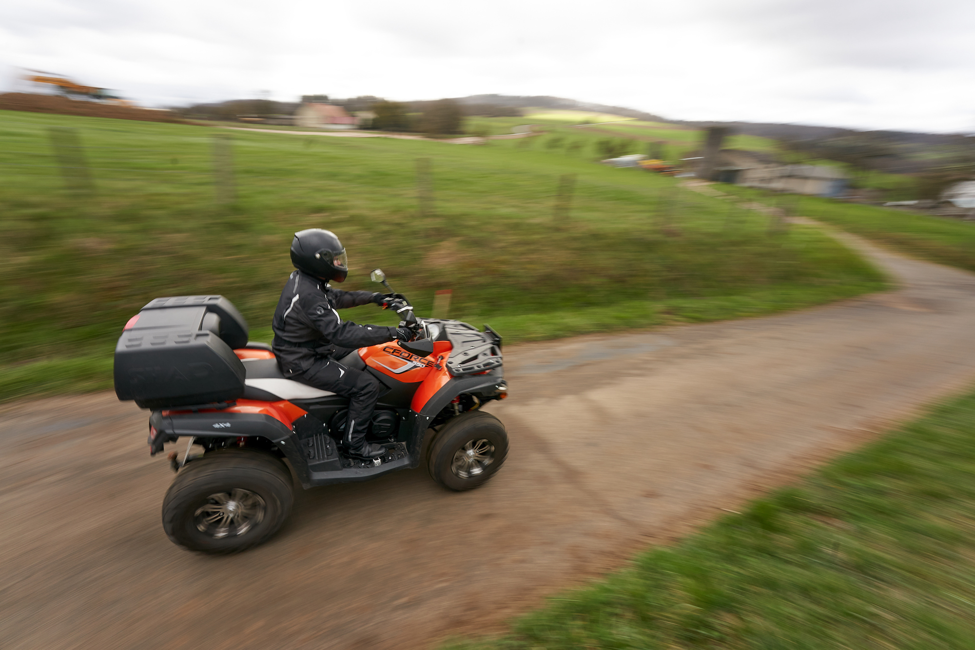 A rider driving a CFORCE ATV on a country road on on March 27, 2021