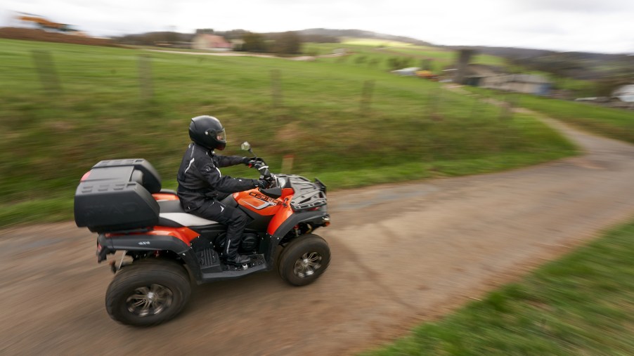 A rider driving a CFORCE ATV on a country road on on March 27, 2021