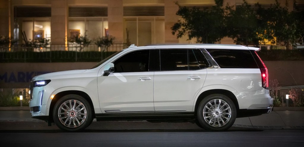 A luxurious white 2021 Cadillac Escalade is parked on a city street.